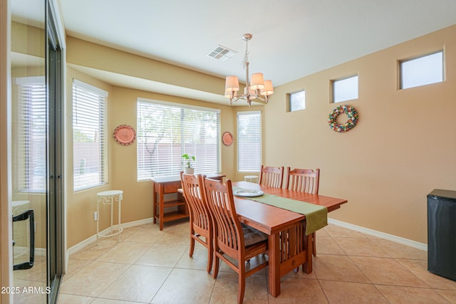 dining space featuring a chandelier and light tile patterned floors