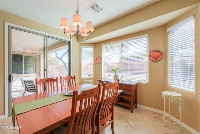 dining area featuring an inviting chandelier and light tile patterned floors