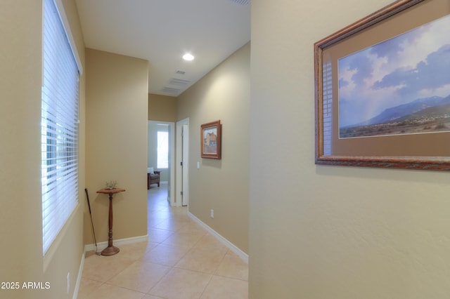 hall featuring light tile patterned floors