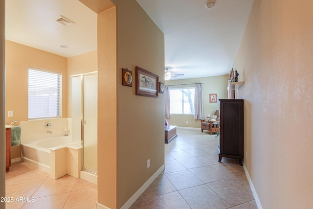 corridor with light tile patterned floors