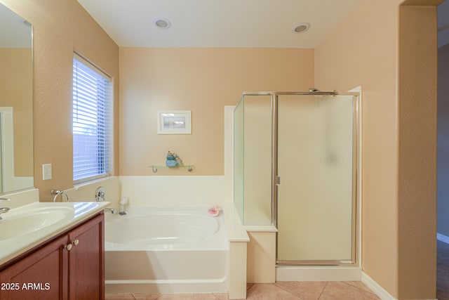 bathroom with tile patterned flooring, vanity, and shower with separate bathtub