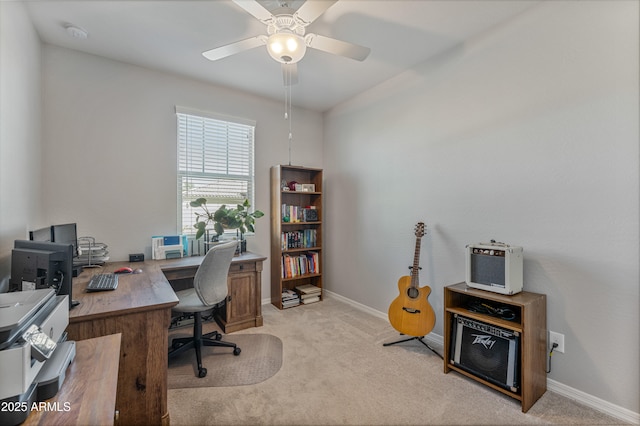 carpeted office space featuring ceiling fan