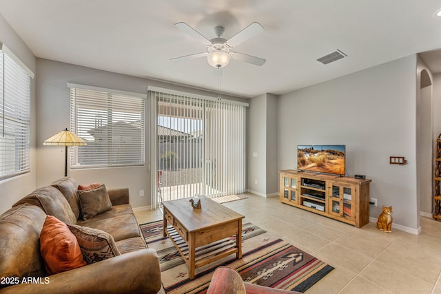 tiled living room with ceiling fan