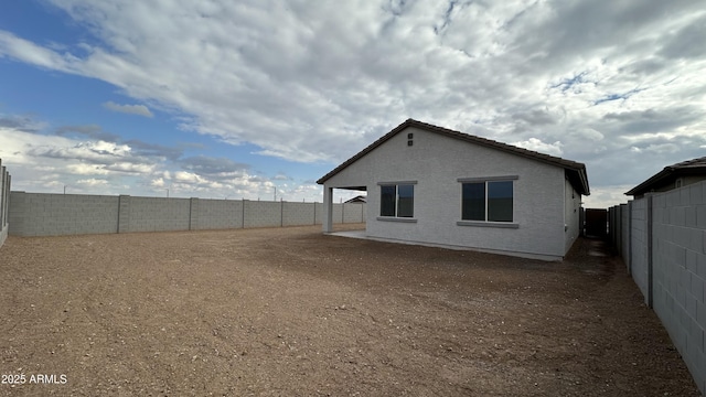 rear view of property featuring a patio area