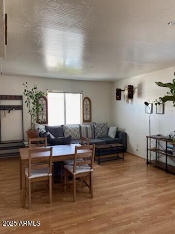 living room featuring light wood-style floors and a textured ceiling