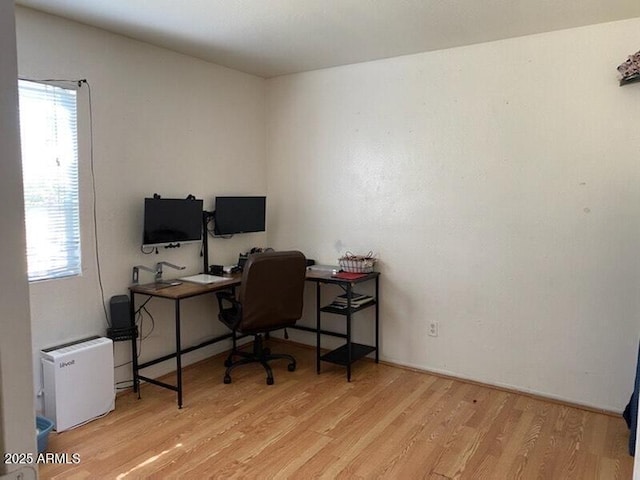 home office with wood finished floors and plenty of natural light