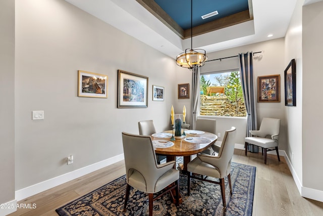 1417 Eureka Ridge Way, Prescott, AZ 86303 - dining area featuring baseboards, light wood-type flooring, a chandelier, a raised ceiling, and recessed lighting
