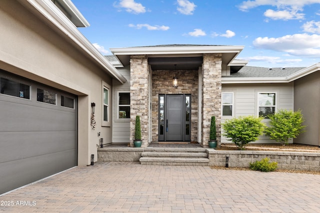 1417 Eureka Ridge Way, Prescott, AZ 86303 - entrance to property featuring stone siding, decorative driveway, an attached garage, and a shingled roof