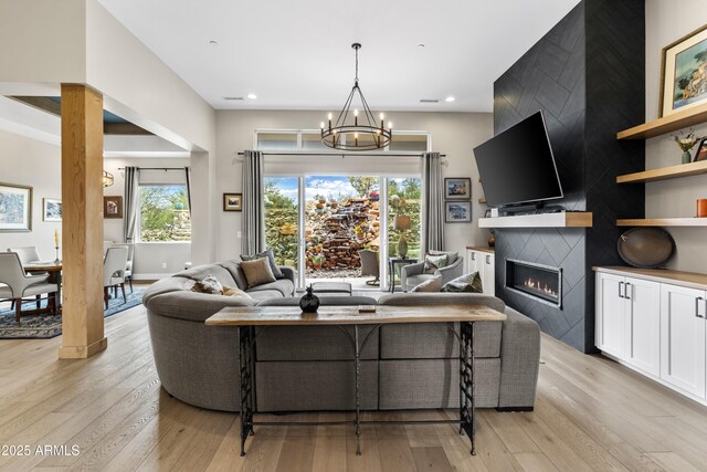1417 Eureka Ridge Way, Prescott, AZ 86303 - living area with a chandelier, light wood finished floors, a fireplace, and recessed lighting