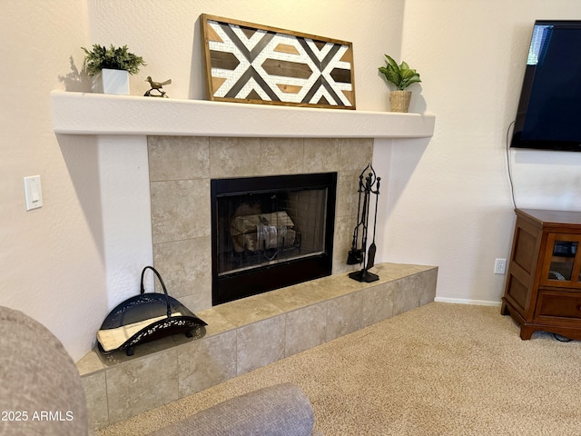 room details with baseboards, carpet, and a fireplace