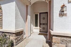 entrance to property featuring stucco siding