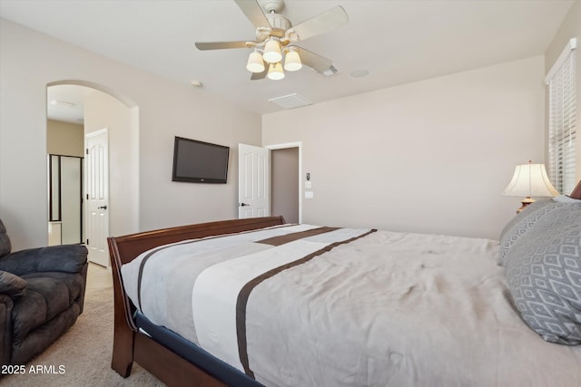 bedroom with arched walkways, carpet floors, and ceiling fan