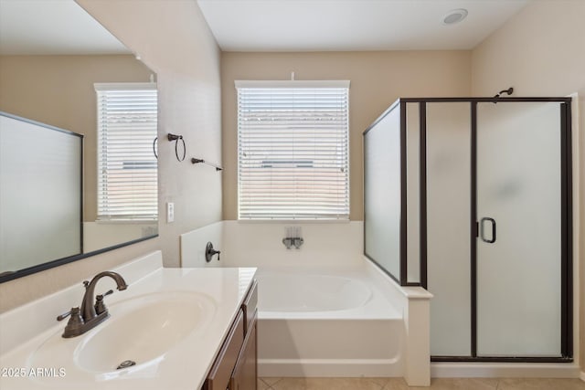 full bathroom featuring a bath, a shower stall, tile patterned floors, and vanity