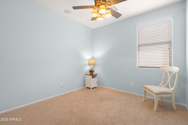 living area with carpet flooring, baseboards, and ceiling fan