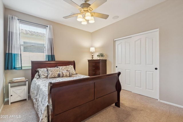 bedroom featuring a closet, baseboards, carpet, and a ceiling fan