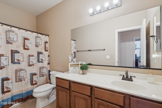 bathroom featuring vanity, tile patterned floors, and toilet