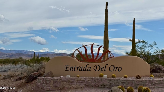 community sign with a mountain view