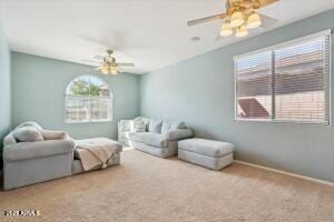 interior space featuring multiple windows, baseboards, and ceiling fan