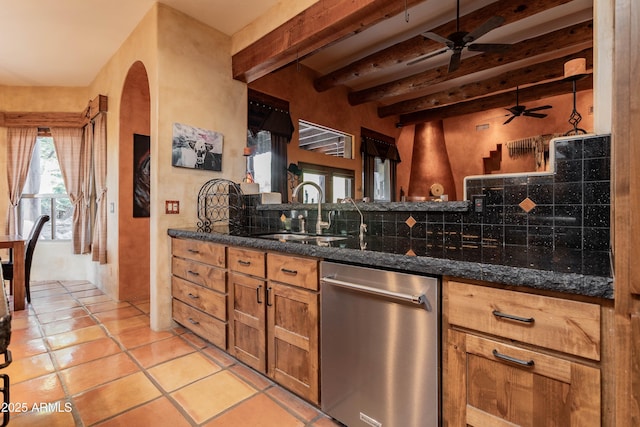 kitchen with stainless steel dishwasher, beam ceiling, a sink, backsplash, and ceiling fan