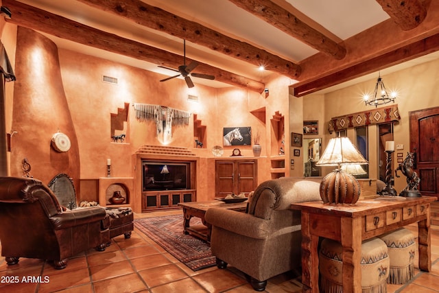tiled living room with a ceiling fan, visible vents, and beam ceiling
