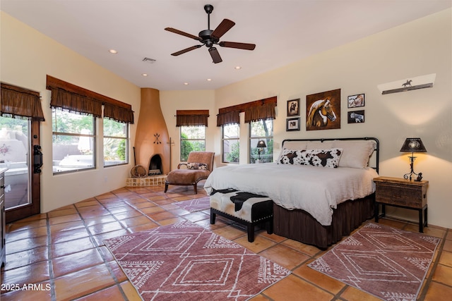 bedroom featuring tile patterned floors, visible vents, and multiple windows