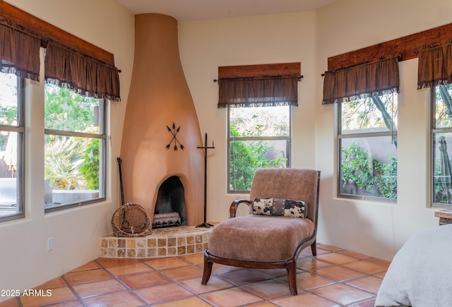 sitting room featuring light tile patterned floors and a fireplace