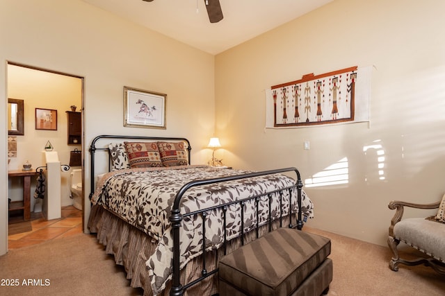 tiled bedroom featuring ensuite bath, carpet flooring, and a ceiling fan