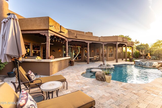 view of swimming pool featuring a patio and a pool with connected hot tub