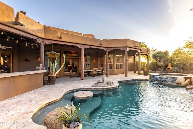 view of pool with french doors, a patio area, and a pool with connected hot tub