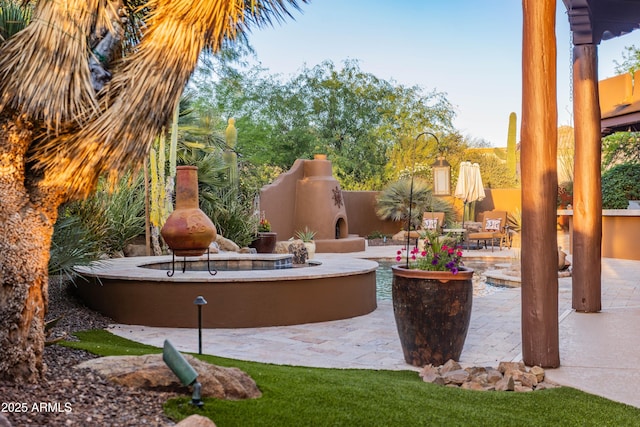 view of patio / terrace with an outdoor fireplace
