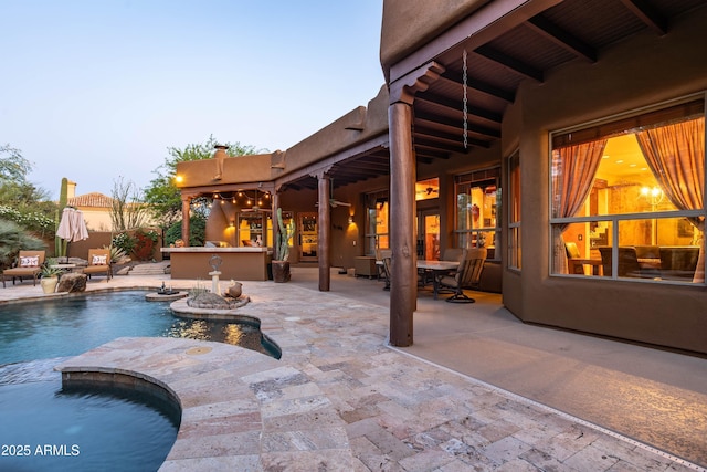 pool with outdoor dry bar and a patio