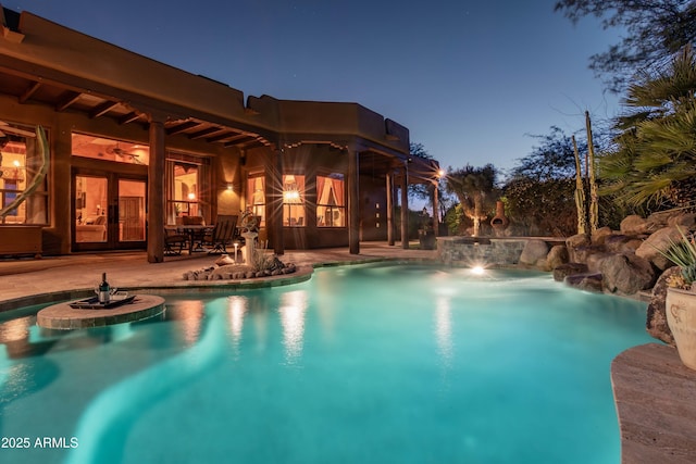 outdoor pool featuring french doors and a patio