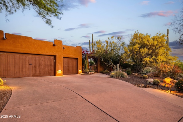 view of side of property with an attached garage and driveway