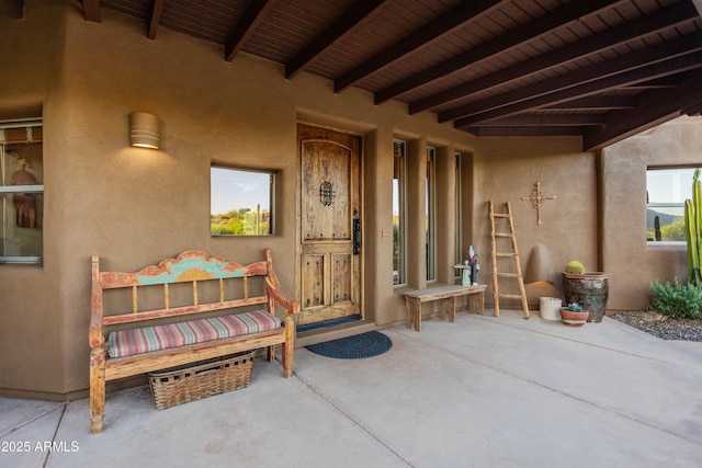 property entrance featuring stucco siding
