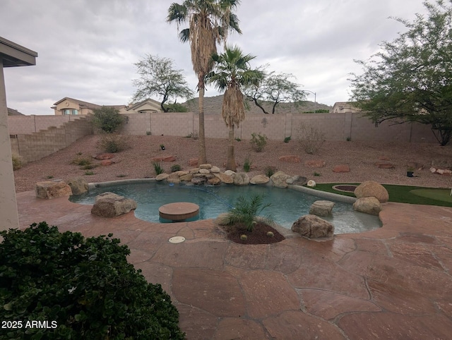 view of pool with a fenced backyard and a patio area