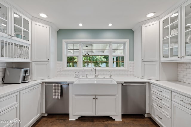 kitchen featuring backsplash, dishwasher, and white cabinets