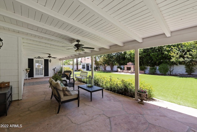 view of patio featuring an outdoor fireplace and ceiling fan