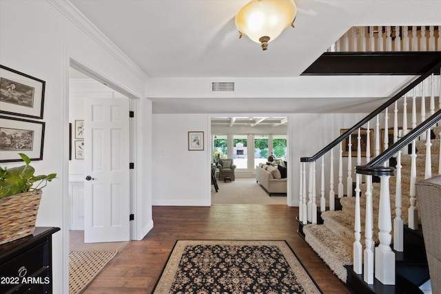 entrance foyer featuring dark hardwood / wood-style flooring, crown molding, beam ceiling, and coffered ceiling