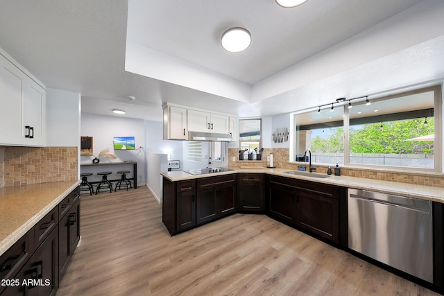 1444 E Myrna Ln, Tempe, AZ 85284 - kitchen with a sink, stainless steel dishwasher, white cabinets, black electric stovetop, and light countertops