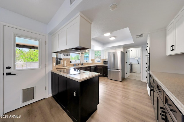 1444 E Myrna Ln, Tempe, AZ 85284 - kitchen with appliances with stainless steel finishes, a sink, a tray ceiling, a peninsula, and white cabinetry