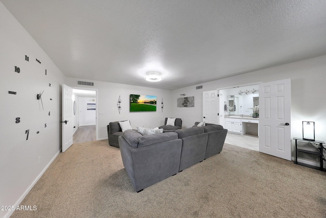 1444 E Myrna Ln, Tempe, AZ 85284 - living area with light colored carpet, baseboards, and a textured ceiling