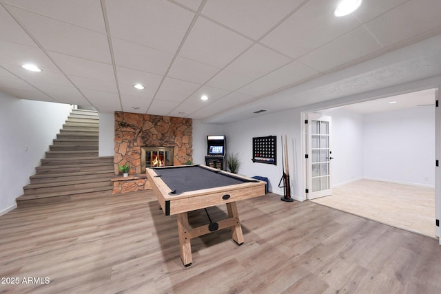 1444 E Myrna Ln, Tempe, AZ 85284 - rec room with billiards table, light wood-style floors, a stone fireplace, baseboards, and a drop ceiling