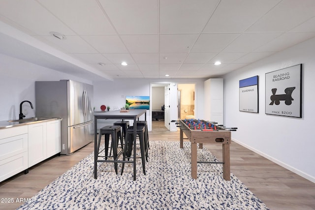 1444 E Myrna Ln, Tempe, AZ 85284 - recreation room featuring a sink, a drop ceiling, baseboards, light wood-style flooring, and recessed lighting