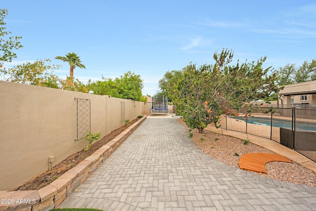 1444 E Myrna Ln, Tempe, AZ 85284 - view of home's community featuring a trampoline, a fenced backyard, a pool, and a patio
