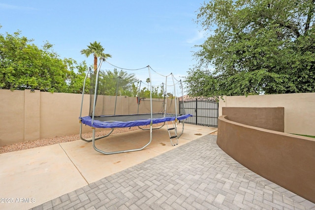 1444 E Myrna Ln, Tempe, AZ 85284 - view of patio / terrace with a trampoline, a fenced backyard, and a gate