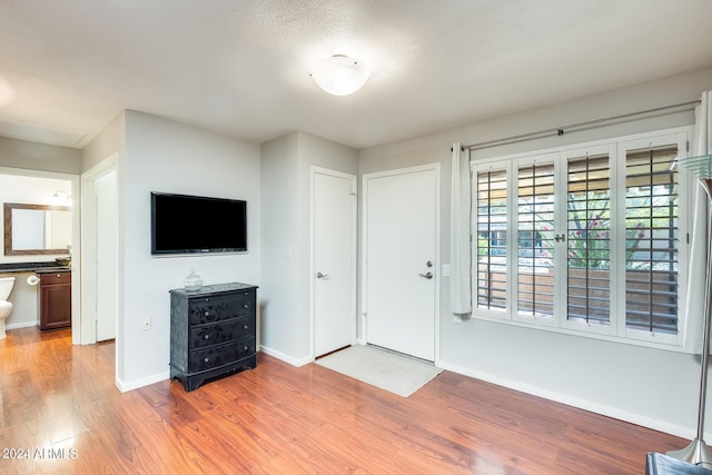 foyer featuring light wood-style flooring and baseboards