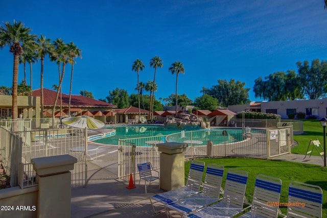 community pool featuring a patio area and fence