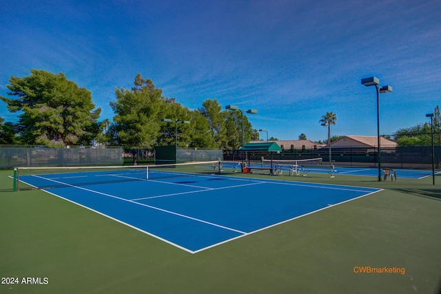 view of tennis court featuring fence