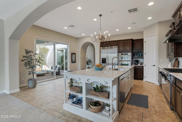 9608 N 184th Ln, Waddell, AZ 85355 - kitchen featuring stainless steel appliances, open shelves, arched walkways, light countertops, and recessed lighting