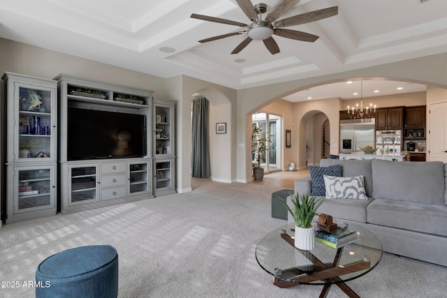 9608 N 184th Ln, Waddell, AZ 85355 - living area featuring arched walkways, light carpet, a chandelier, ceiling fan, and a tray ceiling